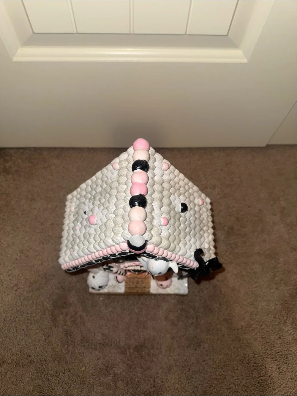 pink and black Halloween gingerbread house is a ceramic light-up figurine